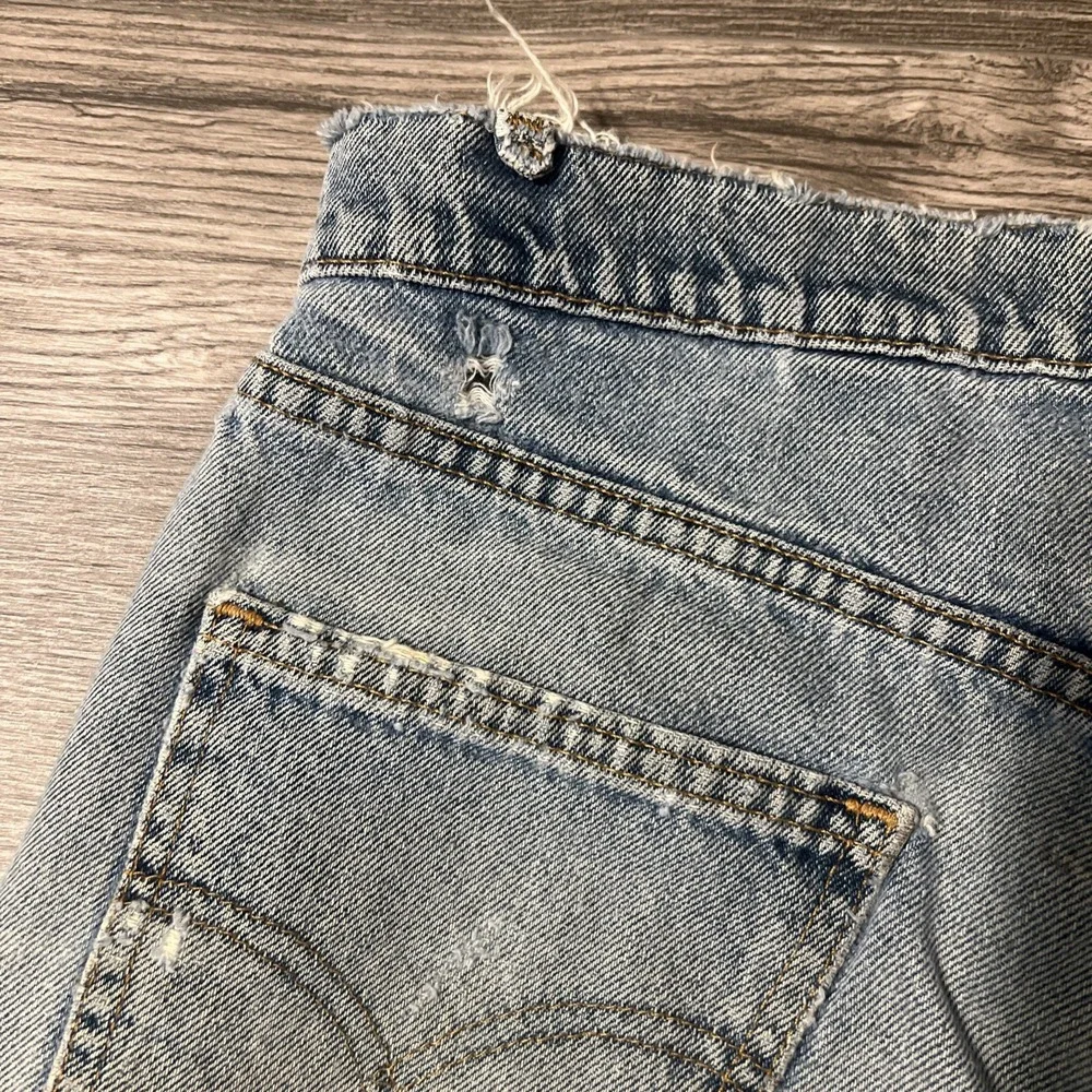 Vintage Levi's 550 Heavily Distressed Light Wash Blue Jean Shorts Size 32x10 USA
